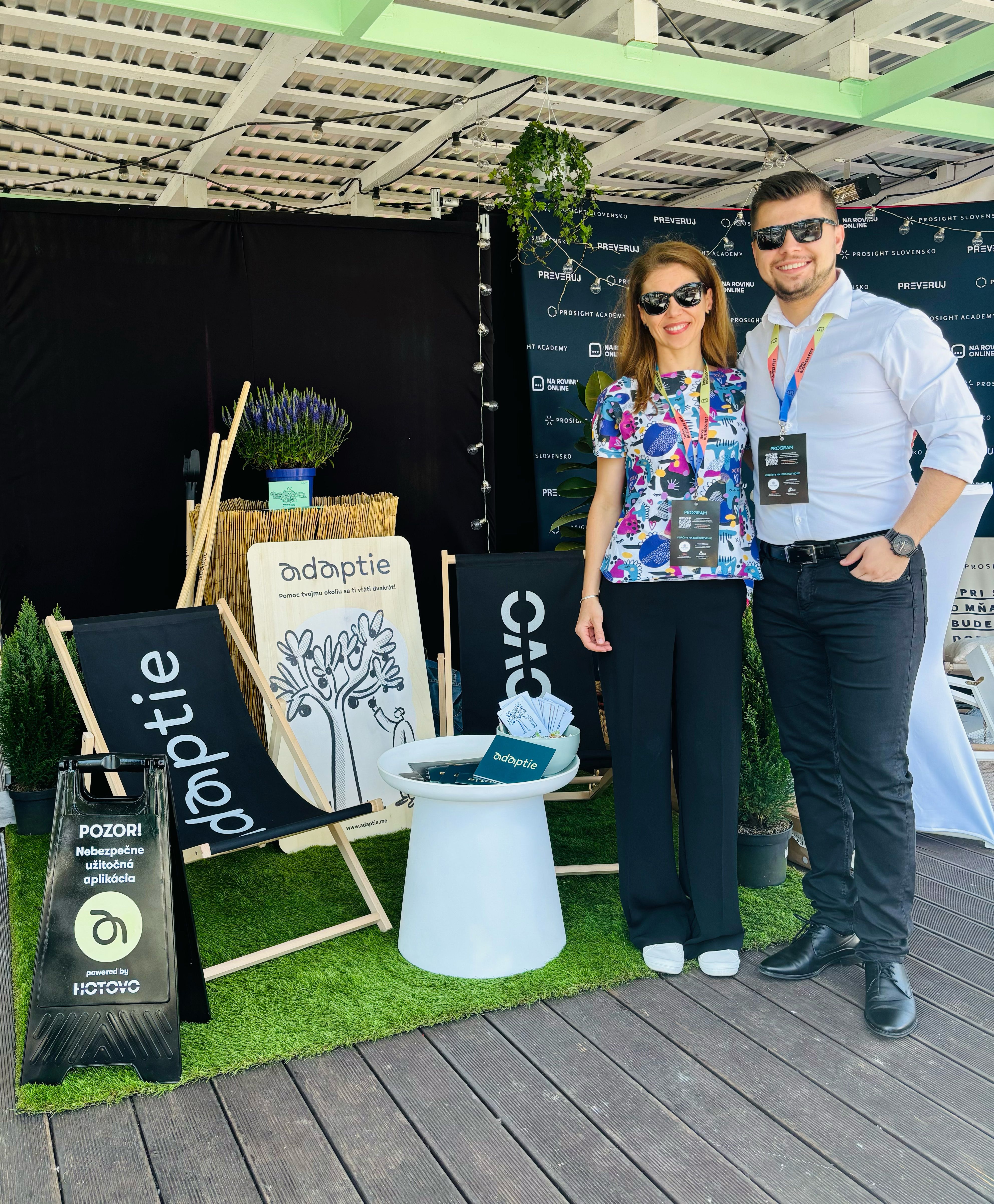 Two people of Adaptie team standing infront of booth